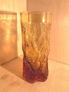 a glass sitting on top of a wooden table