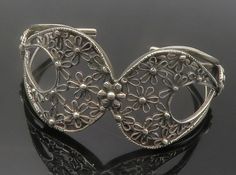 "925 Sterling Silver - Vintage Open Flower Design Tapered Cuff Bracelet - BT5435  925 Sterling Silver - Vintage Open Flower Design Tapered Cuff Bracelet - BT5435  Jewelry Type:         Bracelet  Metal Type:            925 Silver  Metal Size:             6.75\" Length  1.25\" Height   Stone Type:            N/A  Condition:              N/A  Jewelry Weight:     25.2 Grams  PLEASE NOTE: THIS ITEM IS PRE-OWNED. ALTHOUGH MOST ITEMS ARE IN VERY GOOD CONDITION, SOME MAY NEED CLEANING AND/OR MINOR REPAIRS. WE MAKE A VERY STRONG EFFORT TO UPLOAD CLEAR PICTURES. PLEASE INSPECT ALL PICTURES AND ASK ALL QUESTIONS YOU MAY HAVE PRIOR TO MAKING A PURCHASE. NOT ALL STONES ARE GENUINE, SOME ARE ENHANCED OR CREATED." Elegant Silver Bracelets For Spring, Elegant Silver Bracelet For Spring, Spring Silver Bracelet Jewelry, Silver Bracelets For Spring, Silver Bangle Cuff Bracelet For Spring, Vintage Bracelet Jewelry For Spring, Vintage Spring Jewelry Bracelet, Vintage Spring Bracelet Jewelry, Silver Formal Jewelry For Spring