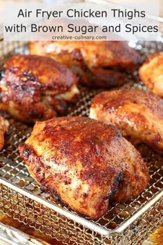 several pieces of chicken sitting on a metal pan with grate in the bottom half