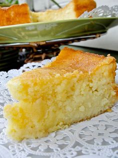 a piece of cake sitting on top of a white doily next to a bowl