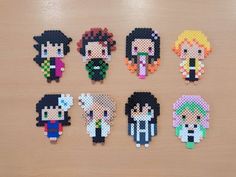 six pixelated characters are displayed on a wooden surface, each with different colors and sizes