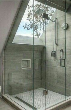 a bathroom with a glass shower stall and toilet