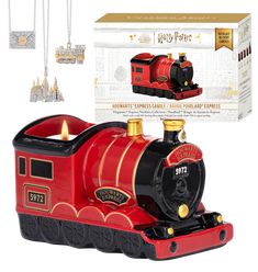 a red and black train ornament in front of a white box with gold accents