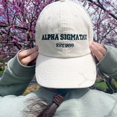 the back of a person's head wearing a hat that reads, alpha sigmattu est 1989