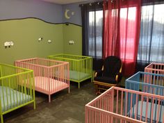 there are many cribs in this nursery room