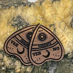 These ouija board planchette piece wood earrings are perfect for any mystic, macabre, spirit board, ghost, or mystery lover in your life. Show off your paranormal side with these beautiful planchette earrings. Laser engraved on a walnut finish they measure approx. 1.5 inches tall and 1.4 inches wide. They hang on gold colored hardware. These earrings are lightweight and compliment any outfit. These are laser engraved and hand assembled in my studio in North Carolina. *Photos are representative o Planchette Earrings, Ouija Board Planchette, Witchy Earrings, Hello Goodbye, Personalized Piggy Bank, Funny Ornaments, Spirit Board, Ouija Board, Wooden Earrings