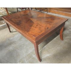 a wooden table sitting on top of a tile floor