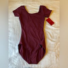 Nwt Burgundy Bodysuit Size Small Red Fitted Short Sleeve Swimwear, Maroon Bodysuit Outfit, Red Fitted Leotard For Summer, Red Stretch Bodysuit With Short Sleeves, Cheap Red Lined Bodysuit, Affordable Red Short Sleeve Bodysuit, Red Fitted One-piece Bodysuit, Red Short Sleeve Cotton Bodysuit, Black Tank Top Bodysuit