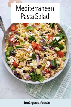 a white bowl filled with pasta and vegetables