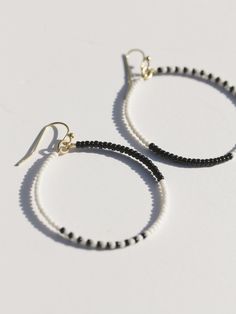 Asymmetrical and fun monochrome beaded hoops for a simple and unexpected look. Fair trade Handcrafted in India Hypoallergenic and nickel free brass + glass beads Measures 2" in length Adjustable Beaded Earrings With Dangling Beads For Everyday, Everyday Beaded Hoop Earrings, Adjustable Black Beaded Hoop Jewelry, Small Hoop Beaded Earrings For Everyday, Adjustable Circular Beaded Earrings With Tiny Beads, Everyday Beaded Hoop Jewelry, Trendy Everyday Beaded Earrings, Minimalist Small Hoop Beaded Jewelry, Minimalist Beaded Earrings With Round Beads For Everyday