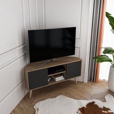 a flat screen tv sitting on top of a wooden stand