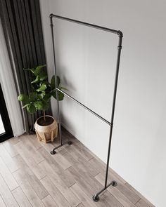 a potted plant sitting on top of a wooden floor next to a white wall