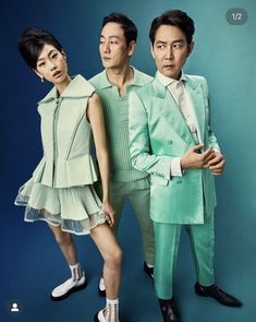 two men and a woman in green outfits