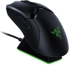 a close up of a computer mouse on a white surface with green light coming from the side