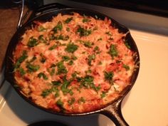 a pan filled with food sitting on top of a stove