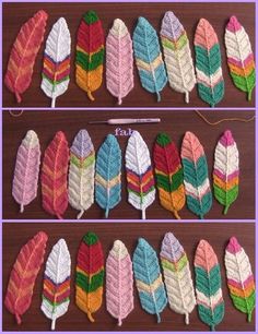 four rows of different colored feathers sitting on top of a wooden table next to each other