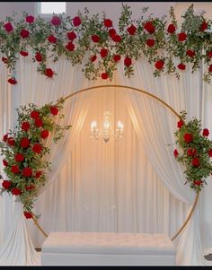 a bed with roses and greenery on the wall next to a chandelier