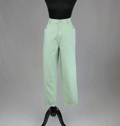 "Description: Vintage light mint green jeans from the 1990s. Zip fly with button at the waist. Relaxed fit. Looks like slightly tapered leg. Five pocket design. Bill Blass patch on back waist. Any condition issues or flaws to note?: Hemmed. I don't see any other issues. No odors. Material: Woven cotton. No stretch. Machine wash, tumble dry. Brand/Label: Bill Blass Any hang tags still attached?: No. Size Marked: Vintage 12 Tall (hemmed to short though) Measurements: Waist: 32\" Hips: 44\" Length down outside edge: 41\" Inseam: 29\" (hemmed) Rise: 13\" including waistband Thigh: 13.5\" across front Ankle opening: 7.5\" across front Measurements for bust/chest, waist, and hips are taken across front and doubled. If there is any stretch to the fabric or if there is elastic I will note it. Dres Mint Green Jeans, Mint Jeans, Pants High Waisted, Light Mint Green, Green Jeans, Bill Blass, Brand Label, Womens Jeans, Dress Form