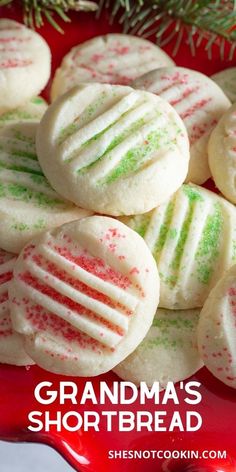 a red plate topped with cookies covered in white and green sprinkles