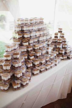 a table topped with lots of cupcakes covered in frosting