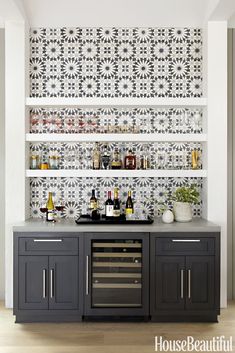 the kitchen is decorated in black and white tiles with silver accents, as well as an open shelving unit