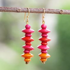 Full of vitality, style and uniqueness, these dangle earrings will add a vibrant aura to your outfits thanks to their sweet palette. Crafted by Ghanaian artisans and designed by Rita Addo Zakour, the accessory is made from painted sese wood beads for a cheerful look. On top of that, they come with brass hooks that allow you to wear them in all their beauty. Bohemian Dangle Earrings With Wooden Beads, Unique Wooden Bead Dangle Jewelry, Bohemian Multicolor Wooden Bead Earrings, Multicolor Wooden Beads Dangle Earrings, Bohemian Wood Dangle Earrings, Brass Hooks, Gift Suggestions, Brass Hook, Buy Wood