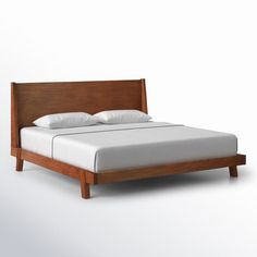 an image of a bed with white sheets and pillows on it's headboard