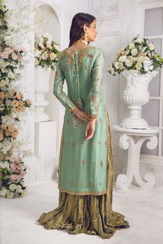 Stunning Sage-green long shirt crafted from Pure silk net, embellished with tila, dabka, nakshi, sequins, pearls, crystals & resham work, pop of red hue and shimmer appliques on hem lines and hand-made tassels to enhance the look of this shirt. Heavily embellished dupatta in breath taking Mukesh work with gold & silver in stunning geometric pattern makes this an absolute favorite, crushed jamawar lehenga completes the look of this outfit. Shirt Fabric: Pure Silk Net Shirt Length: 48” (customisab Mukesh Work, Net Shirt, Resham Work, Designer Outfit, Pop Of Red, Pakistani Designers, Take A Breath, Shirt Fabric, Long Shirt