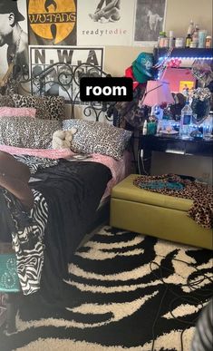 a bedroom with a zebra print rug and black and white bedding on the floor