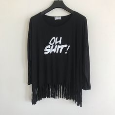 Fringe Tee “Oh Shit!“ Color:Black One Size Made In Usa Brand New Long Sleeve Slogan Tops For Summer, Summer Long Sleeve Slogan Top, Summer Long Sleeve Tops With Slogan, Long Sleeve Fringe Tops For Summer, Black Long Sleeve Shirt With Text Print, Casual Cotton T-shirt With Fringe, Oversized Black Slogan Top, Stretch Cotton Blouse With Graphic Print, Chic Black Crew Neck T-shirt