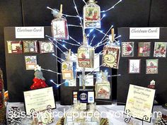 a table topped with lots of cards and bottles on top of a white table cloth