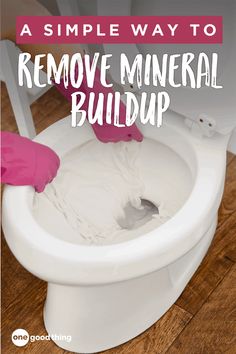 someone cleaning a white toilet with the words, a simple way to remove mineral buildup