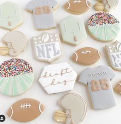 decorated cookies are arranged in the shape of footballs