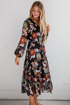 The Prepared To Impress Black Floral Midi Dress will have you more than ready to be the talk of any party! Crafted from a soft, breathable fabric, this dress features a classic black background adorned with vibrant floral patterns that pop beautifully, making it perfect for any season. The flattering midi length provides versatility, allowing you to dress it up for special occasions or keep it casual for everyday wear. With its fitted bodice and gently flared skirt, this dress accentuates your f Elegant Black Floral Maxi Dress, Black V-neck Midi Dress With Floral Print, Elegant Black Maxi Dress For Garden Party, Elegant Black Floral Dress For Spring, Black Floral Print Maxi Dress For Fall, Black Floral Print Spring Dress, Black Floral Print Dress For Spring, Black Floral Dress For Spring, Spring Black Floral Dress