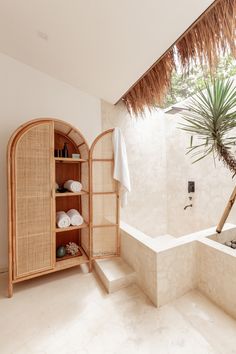 a bathroom with a sink, bathtub and palm tree