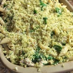 a casserole dish with broccoli and pasta in it