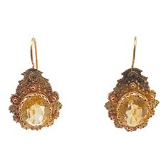 This is part of Chairish’s Fine Jewelry assortment.  A wonderful pair of Victorian period pierced earrings with a prong set citrine in the center.  The tear drop setting has Etrsucan beadwork alternating yellow and rose gold flowers.  The wires are French with a hook at the bottom.  They test 14K but have no marks.  Condition is excellent.  The citrines measure 10 mm X 8 mm, or 2.4 carats.  Dimensions: Length from top of wire, 1 1/4", The drop measures 1" by 5/8", Weight: 2.4 grams Elegant Formal Citrine Earrings, Fine Jewelry Citrine Earrings For Wedding, Citrine Wedding Earrings Fine Jewelry, Citrine Fine Jewelry Earrings For Wedding, Wedding Fine Jewelry Citrine Earrings, Yellow Briolette Earrings For Formal Occasions, Elegant Oval Citrine Earrings, Citrine Drop Earrings For Wedding, Yellow Earrings With 17 Jewels For Formal Occasions