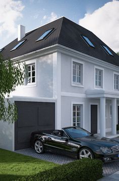 a black car parked in front of a white two story house with a gray roof