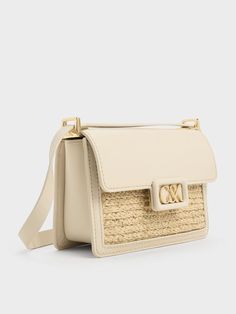 Travel light this summer with this leather and raffia boxy bag. This cute yet polished carrier juxtaposes a rustic woven texture against smooth calf leather -- it will stand out wherever you go. Made compact for convenience, it will hold all your essentials with ease. In neutral-toned beige, it is versatile enough to complement most outfits. Adjust the shoulder strap to your preference, or remove it entirely to transform this chic bag into a clutch. Boxy Bags, Brand Collaboration, Chic Bags, Woven Texture, Charles Keith, Travel Light, Neutral Tones, Kids Gifts, Trending Shoes