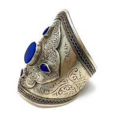 Gorgeous bold Afghani oxidized finish cuff studded with big blue gypsy stone in the middle and small ones on the side. Engravings all over the cuff. Limited availability. Metal: Alloy Material: Stone Width: 1 to 4 Inch in the middle Style Tip: Pair it with chic trendy wear for an evening out with friends. The color of the stone will stand out on any outfit. Style Personality: Street Stylish: You have an electric and eccentric style cause you love to stand out from the crowd. You express your ene Eccentric Style, Engraved Metal, Metal Engraving, Big Blue, Outfit Style, Antique Finish, Blue Stone, Boho Chic, 4 Inch