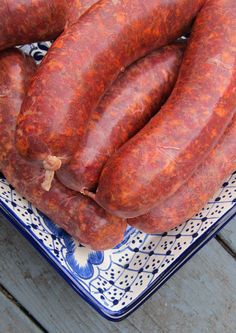 several sausages on a blue and white plate