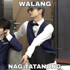 two young men sitting next to each other in front of a metal door with the words walang nag tatanong on it