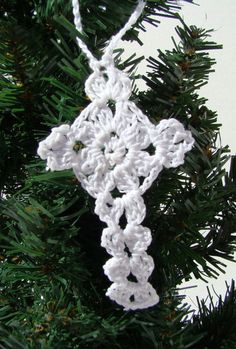 a crocheted snowflake ornament hanging from a christmas tree branch