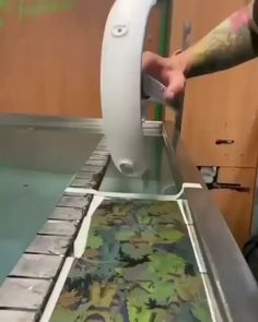 a man is using a machine to print flowers