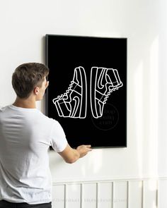 a man is holding up a black and white poster