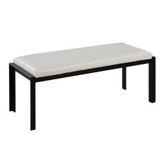 a white bench sitting on top of a wooden table next to a black metal frame