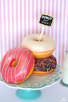 two donuts on a plate with a sign that says donut last bite next to them