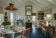 a dining room with blue flooring and white walls