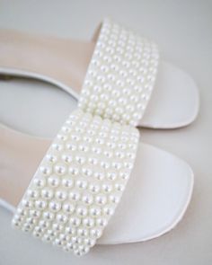 Classic slide flat sandals with pearls on upper is best for casual and dressy look. Simple and easy wear for brides, bridesmaids and wedding parties. The delicate pearl beads are placed carefully by hand made to order to create a graceful classic design.DETAILS:UPPER: Synthetic upper and liningMATERIALS: Manmade outsoleORIGIN: Imported Sandals With Pearls, Slip On Sandals, Wedding Parties, Satin Slip, White Flats, Sheet Of Paper, Easy Wear, Flat Sandals, Pearl Beads