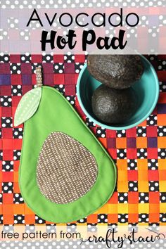 the avocado hot pad is next to a bowl with rocks in it on a colorful table cloth